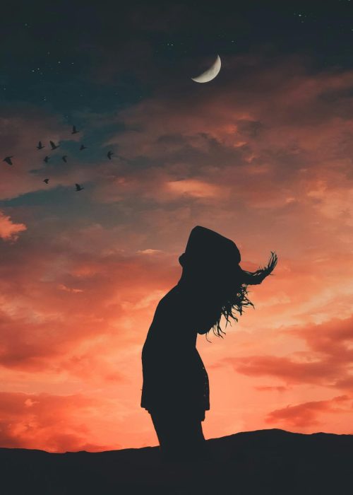 pexels-photo-1835016-1835016 A silhouetted person under a crescent moon at twilight, evoking tranquil and peaceful vibes.